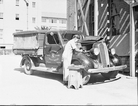 Boy repairing truck, c. 1935
