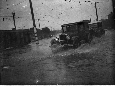 Cars on flooded street, 1930s