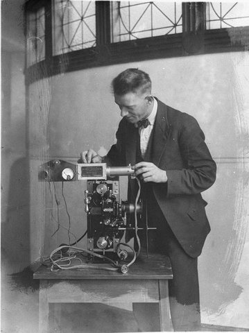 Charles Ward sound engineer fitting the soundhead to the projector of the De Forest Phonofilms sound film system, 1927