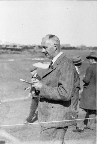 Col Bertram checking scorecard, 1930s