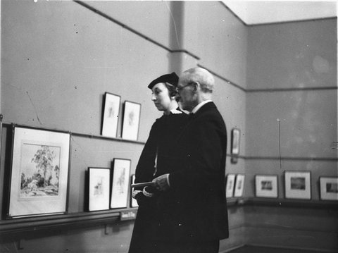 Couple viewing works of art at Art Gallery, 1930s
