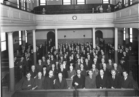 Crowd in auditorium of a church trade or town hall, 1930s