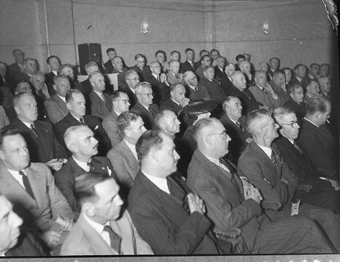 Crowd of men in the auditorium listening to the speakers Timber Homes Display, 1944