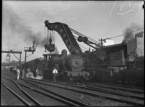 Derailed steam locomotive no 3337 being rerailed, 1956