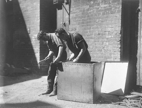 Fitters rivet the airtight box from which Murray the Escapologist proposes to escape in a Tivoli show, 1928