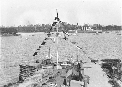 Flag bedecked Fort Denison Pinchgut and HMAS Canberra, 1932