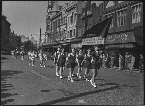 Floral march basketball teams march along Hunter and King Streets near Civic Park Newcastle, 1953