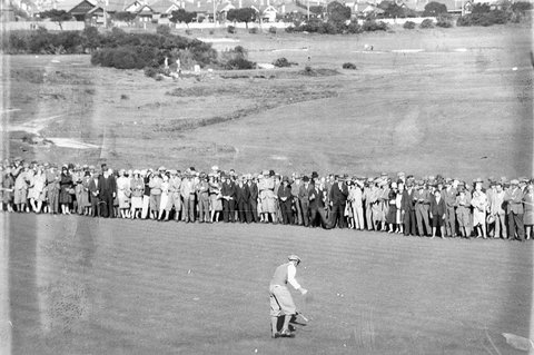 Golfer watched by spectators, 1930s