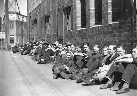 Group of factory workers sunning themselves in the street, 1934