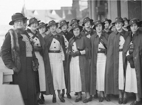 Group of graduate nurses in hats and rain cloaks, 1930s
