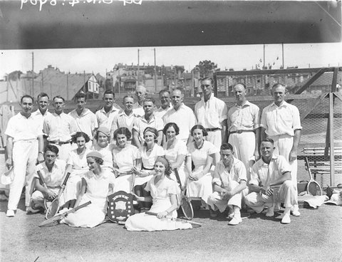 Group of men and women tennis players with shield White City, c. 1930
