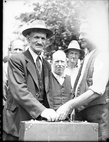 Group of men with suitcase, 1935