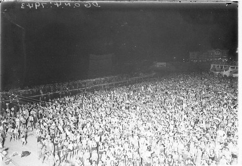 Huge crowd of surfers on Coogee Beach at night, 1930s