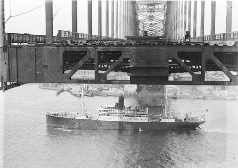 Looking south from the riggers box showing middle section of decking in place with passenger ship passing below Vehicular wharves in distance, 1930–32