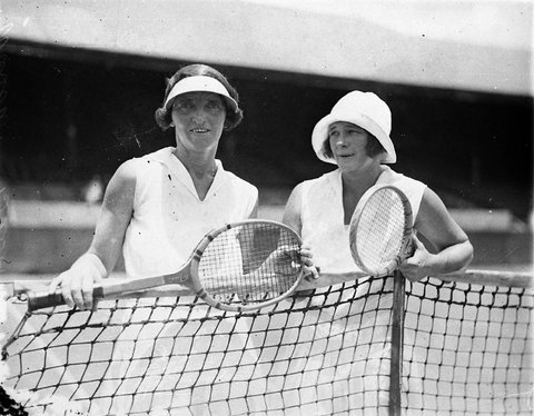 Miss R Wilson and opponent at the net wearing hats, c. 1930