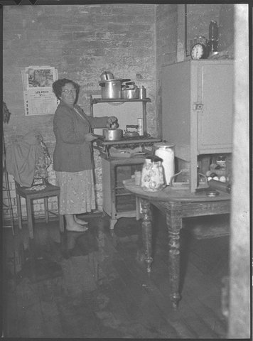 Miss Tinson of Oakhampton cleans flooded house, 1952