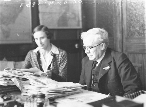 Mr AE Grace Micks father the head of Grace Bros department store and his secretary in his office, 1930s