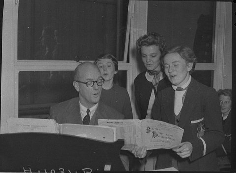 Music supervisor with group of students, 1955