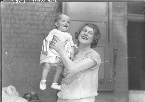 Musical comedy star Dorothy Brunton holding a small child, 1925