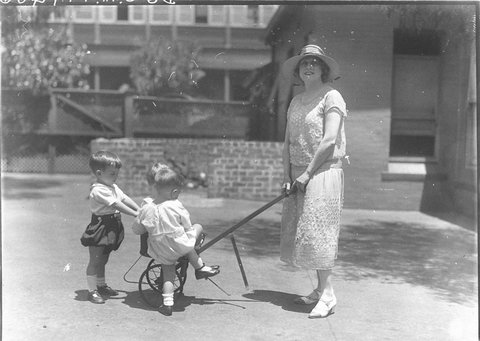 Musical comedy star Dorothy Brunton with three small children and a stroller, 1925