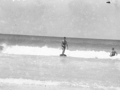 Old style 9 feet long surf board riding at Bondi, 1935