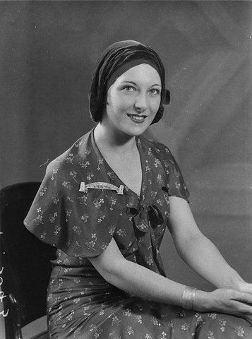 Portrait of unidentified woman wearing snood with Harbour Bridge brooch, 1930s