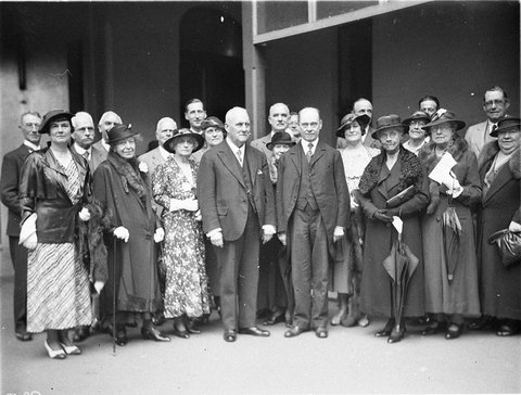 Presentation of a cheque to two unidentified men by large group of women, 1930s