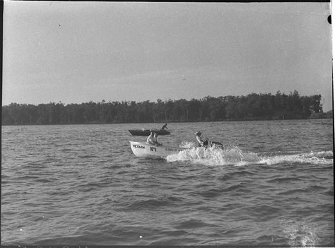Raymond Terrace floodboat tried out by President of Port Stephens Shire President of Hexham Progress Association Mr K Donnelly left and Cr L Ernst of Lower Hunter Shire Council, 1957
