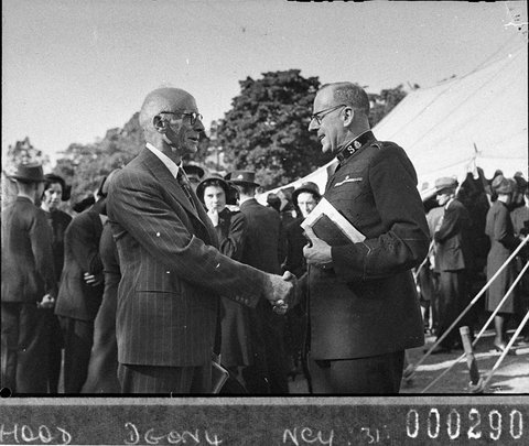 Salvation Army officer shaking hands with a male civilian, 1941