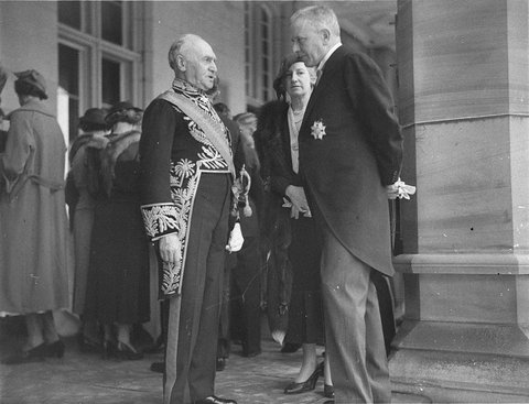 Governor-General Sir Isaac Isaacs talking with Sir Claude Reading, chairman of the Commonwealth Bank, and Caroline Reading, at an honours investiture, Government House, Sydney (15 September 1934)