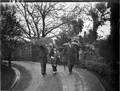 Sir Richard and Lady Sheldon arrive in rain for WhitneyFriend wedding reception Wirian, 1934