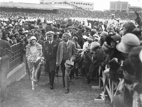 Smiling royal couple cheered by crowds at the Sydney Cricket Ground, 1927