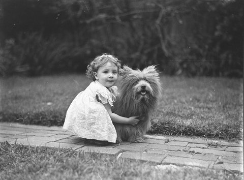 Study of a small girl with a prize Scottish terrier dog, c. 1935