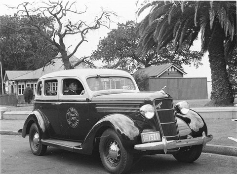 The All British cab service an American 1935 Dodge car with uniformed driver, 1930s