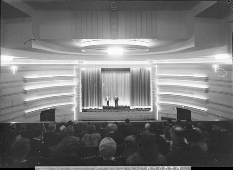 The new Kings Theatre Mosman View of illuminated proscenium from dress circle showing manager on stage making opening speech, 1937