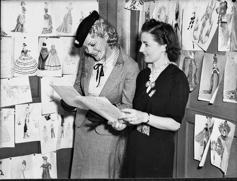 Thelma Afford shows costume designs to model Miss DFahey Sesquicentenary preparations at Town Hall, 1937