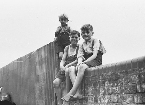 Three boys watch the repair of the railway line at Glebe Road bridge, 1935