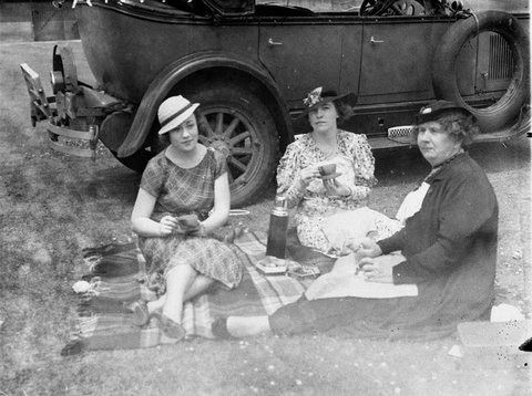 Three women having a picnic tea beside their 1927 Buick Six at the NSWVictoria 2nd XI Cricket Sydney, 1934