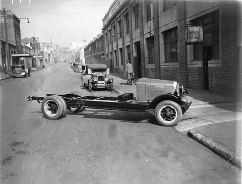Truck chassis Willys Knight sedan behind, 1930s