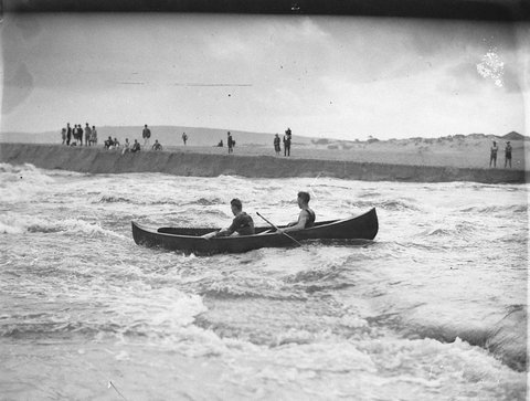 Two canoeists brave the rapids where Narrabeen Lake flood pours into the sea, 1927