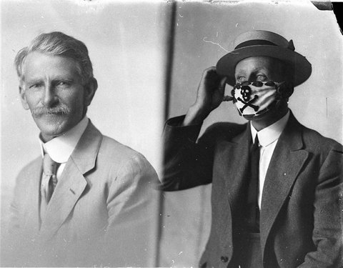 Two different men one wearing the compulsory mask brought in to combat the epidemic of flu in 1919