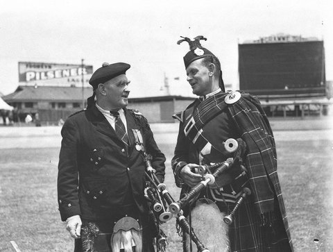 Two Highland pipers talking together at the Highland Societys Caledonian Games, 1935