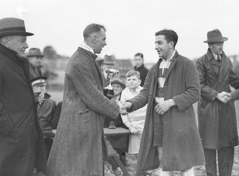Unidentified footballer receives trophy, 1930s