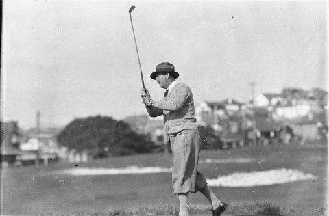 Unidentified golfer driving down fairway to 2nd green, 1925–57