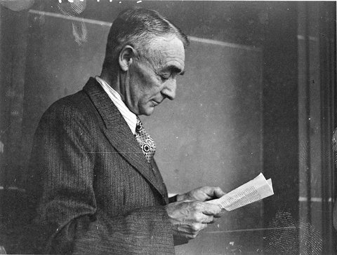 Unidentified man reading a typed letter possibly Teachers Federation Conference 1934