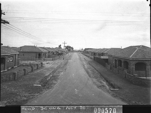 Unsealed suburban street with houses on each side taken for Mascot Council, 1938