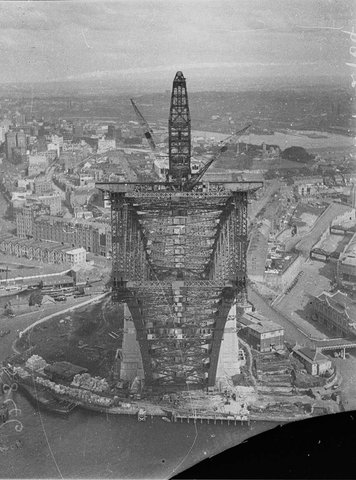View from pulleywheels of north side creepercrane jibbed right out looking into box section of south side arch Sydney Harbour Bridge, 1930