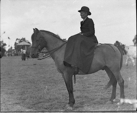 Woman in full skirted dressage on horseback at Liverpool Show, 1935