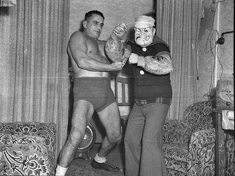 Wrestler Ray Steele and cartoon character Popeye at the Tivoli taken for Stadiums Ltd, 1938