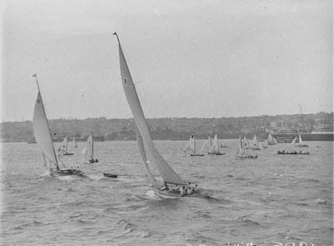 Yachts passing in foreground, 1930s